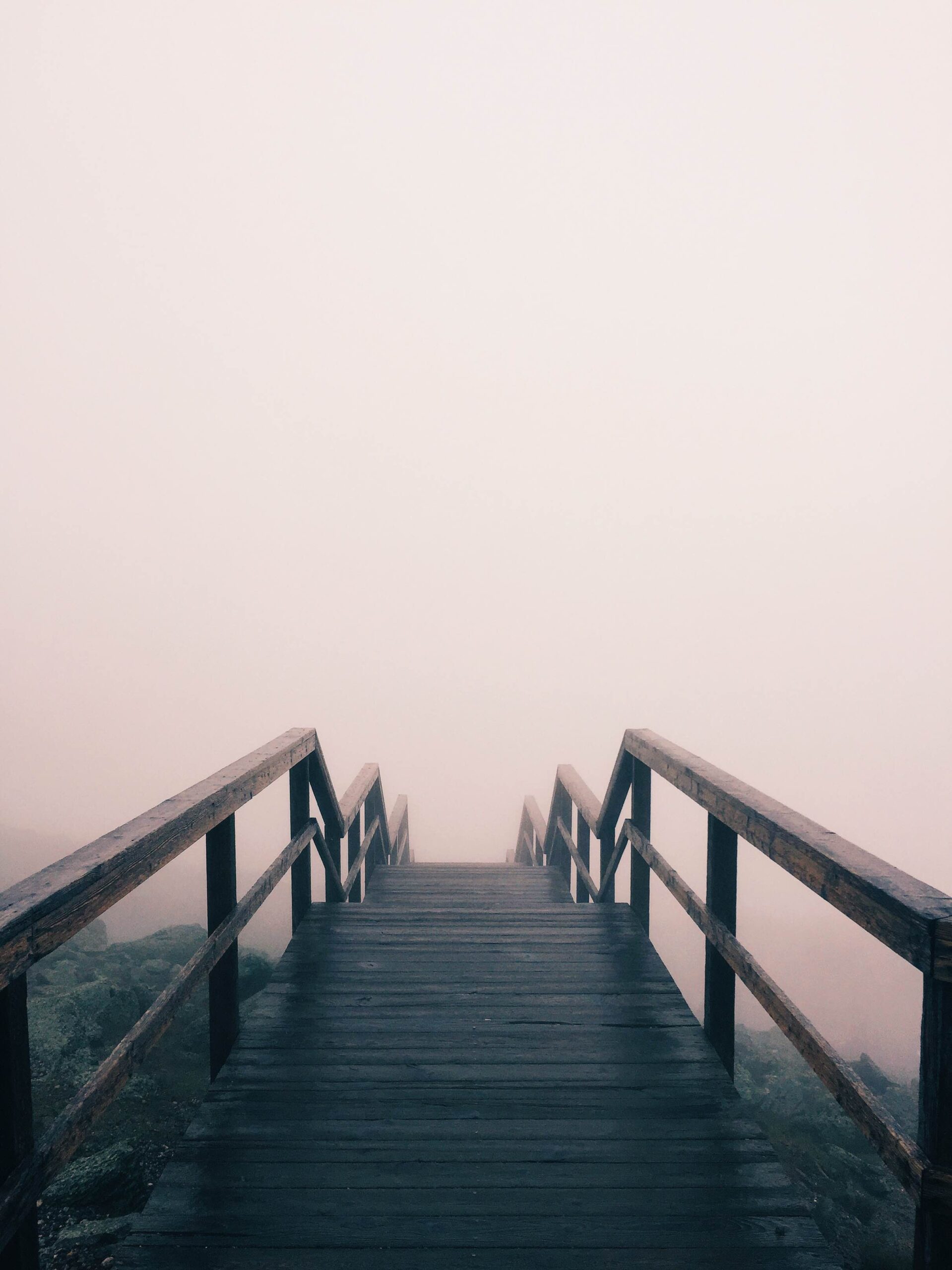 Board walk rising out of fog